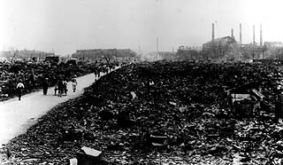 photo: a ruined residential neighborhood, with all the homes burnt or toppled