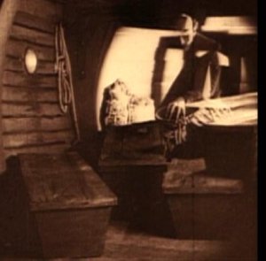 film still: a pile of coffins on-board the ship, from Nosferatu