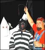photo: frat brothers, one in blackface, pose a mock lynching.