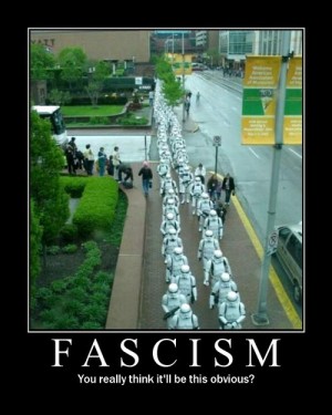 It has a photo of a column of people dressed as Imperial Storm Troopers from Star Wars is marching down a city street. Caption: Fascism: You really think it'll be this obvious?