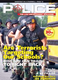 Here's a cover with a photo of a line of about 5 or 6 armored SWAT police in body armor and helmets, coming around the corner of a yellow school bus, with the caption "Are Terrorists Targeting Our Schools?"