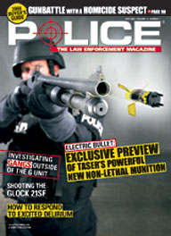 Here's a cover with a photo of an armored SWAT police firing a huge TASER shotgun obliquely at the camera, with the shock-delivery projectile actually flying out towards the viewer.