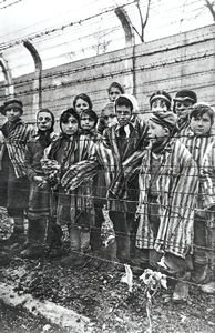 photo: Child prisoners behind the barbed wire at Auschwitz